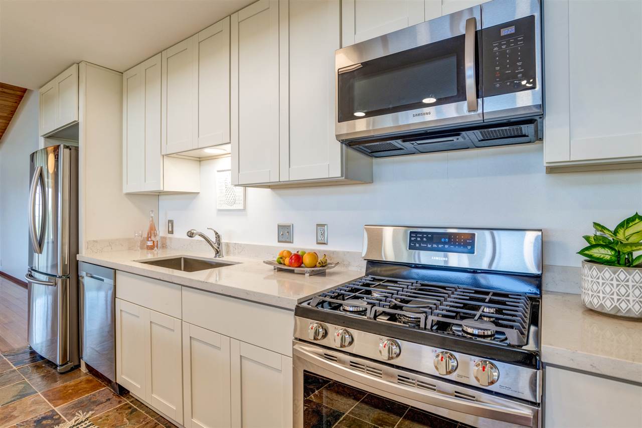 238 South Holokai Road Haiku, HI 96708 - Photo 11 of 28 a kitchen with stainless steel appliances granite countertop a sink stove and microwave