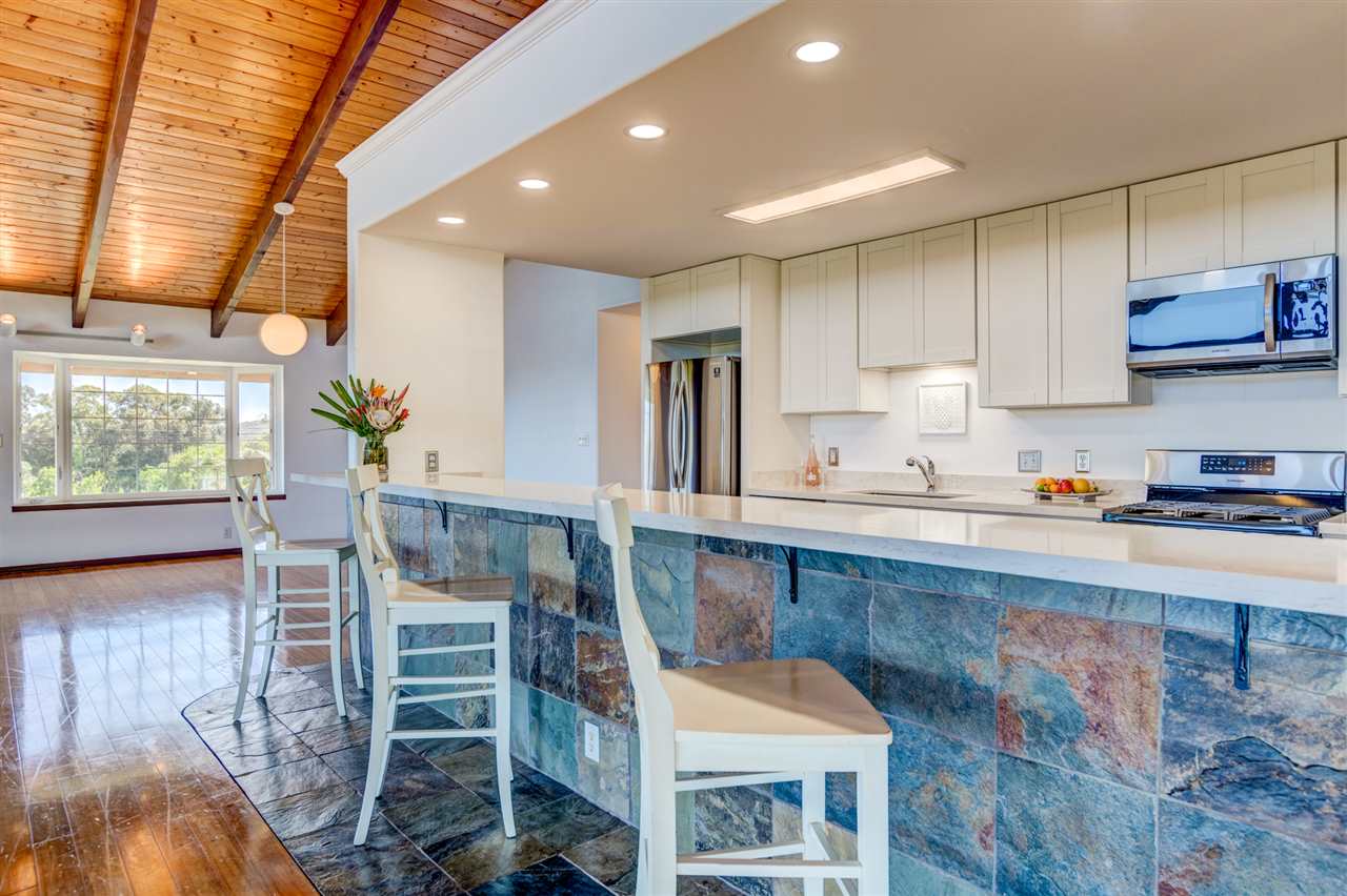 238 South Holokai Road Haiku, HI 96708 - Photo 13 of 28 a kitchen with stainless steel appliances granite countertop a stove top oven a sink and cabinets