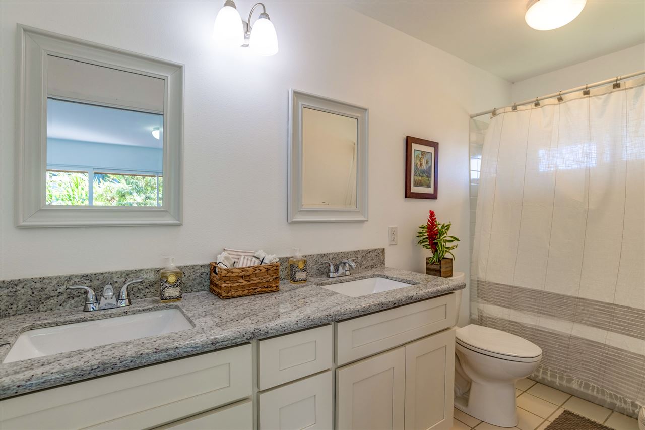 238 South Holokai Road Haiku, HI 96708 - Photo 16 of 28 a bathroom with a granite countertop sink mirror vanity and toilet