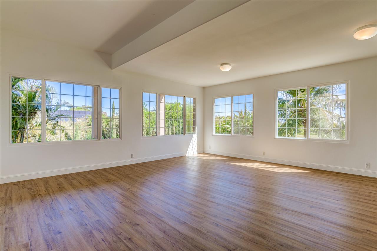 238 South Holokai Road Haiku, HI 96708 - Photo 20 of 28 a view of an empty room with wooden floor and windows