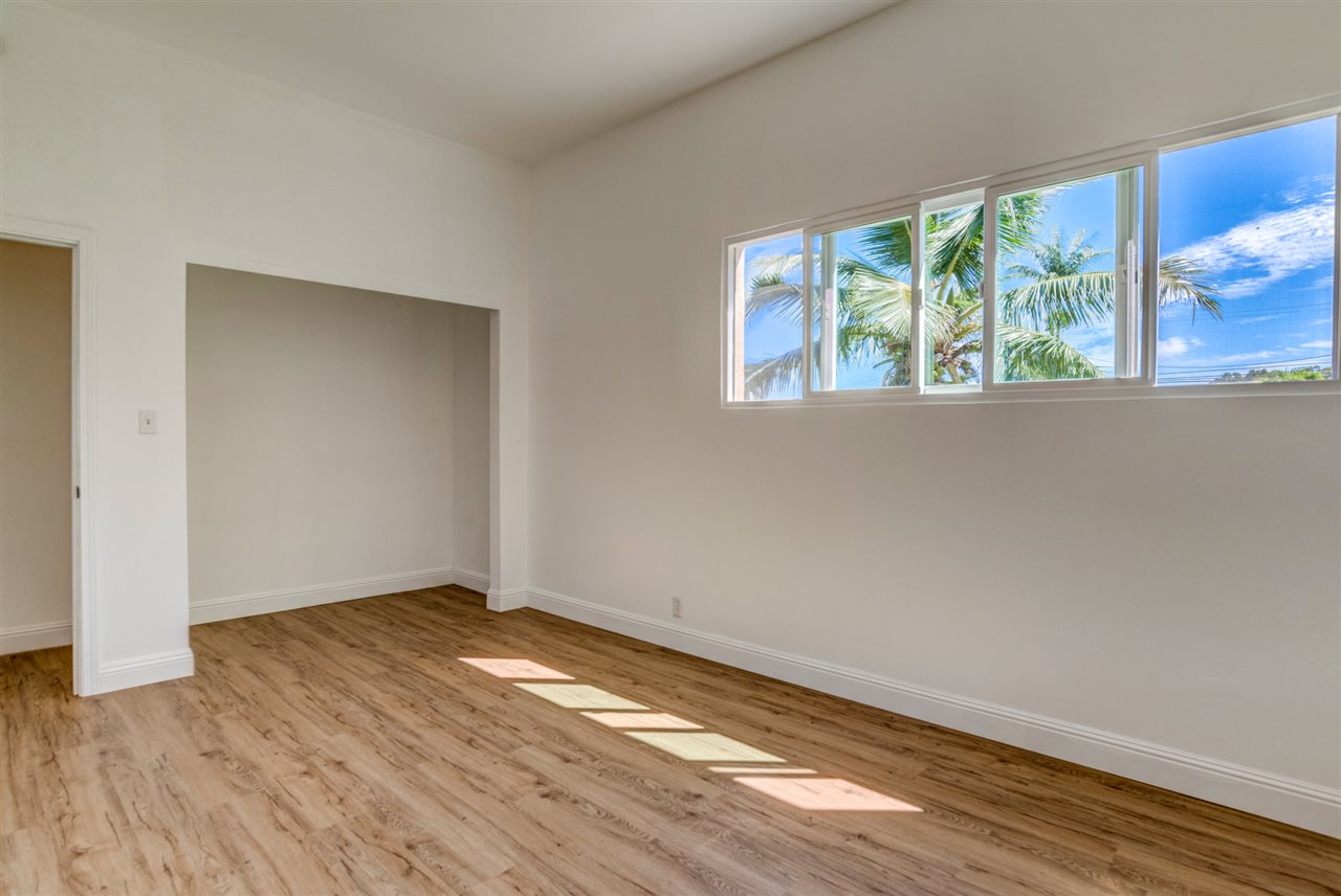 238 South Holokai Road Haiku, HI 96708 - Photo 22 of 28 a view of an empty room with wooden floor and a window