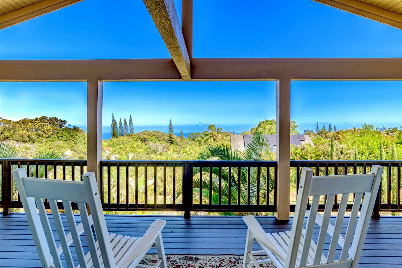238 South Holokai Road Haiku, HI 96708 - Photo 6 of 28 a view of a balcony with chair and wooden floor
