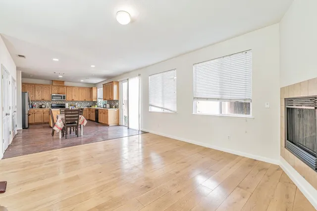 a view of a livingroom with furniture wooden floor and windows
