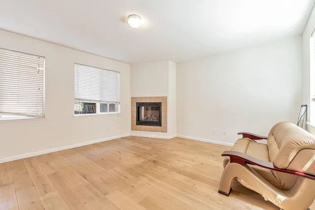 a room with windows and lounge chair