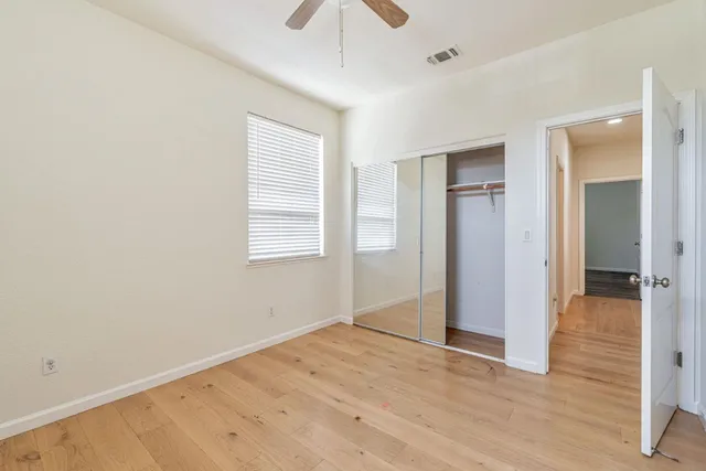 wooden floor in an empty room with a window