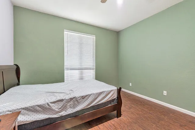 a bedroom with a bed and window