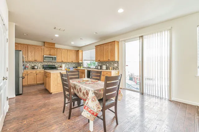 a kitchen with kitchen island wooden cabinets and stainless steel appliances