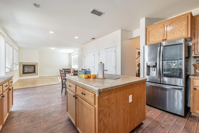 a kitchen with stainless steel appliances granite countertop a refrigerator a sink and a stove