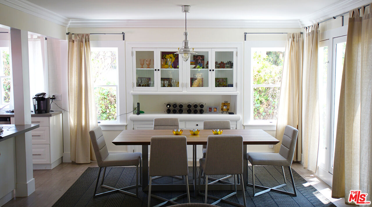 1722 Nichols Canyon Road Los Angeles, CA 90046 - Photo 4 of 11 a view of a dining room with furniture windows and wooden floor