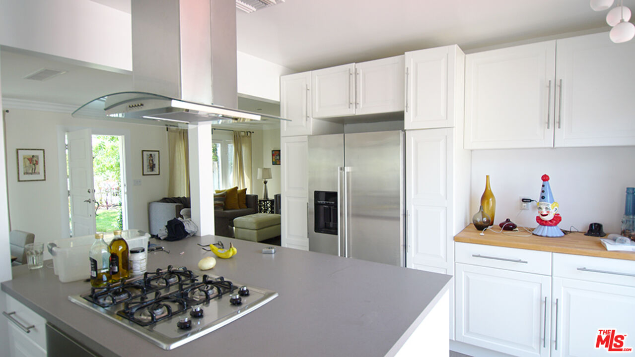 1722 Nichols Canyon Road Los Angeles, CA 90046 - Photo 7 of 11 a kitchen with stainless steel appliances a stove a refrigerator and cabinets
