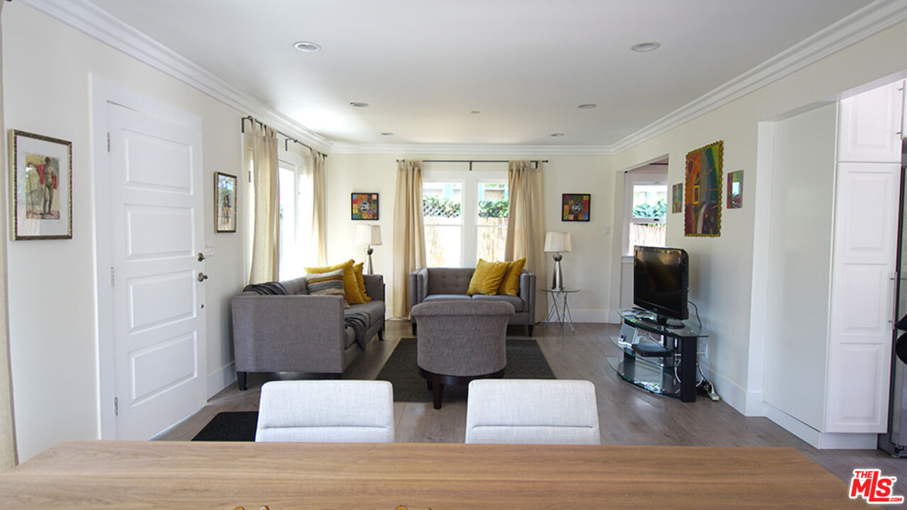 1722 Nichols Canyon Road Los Angeles, CA 90046 - Photo 8 of 11 a living room with furniture a flat screen tv and a window