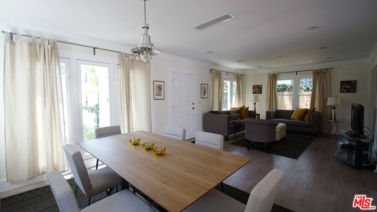 1722 Nichols Canyon Road Los Angeles, CA 90046 - Photo 9 of 11 a living room with furniture a flat screen tv and a window