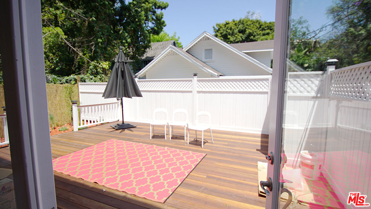 1722 Nichols Canyon Road Los Angeles, CA 90046 - Photo 10 of 11 a view of a balcony with floor to ceiling windows with wooden floor