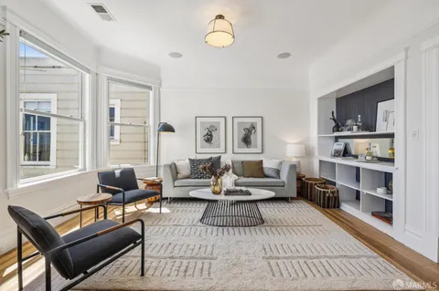 a living room with furniture a rug and a window