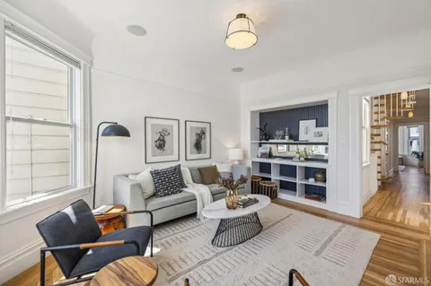 a living room with furniture and floor to ceiling window