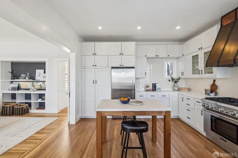a kitchen with stainless steel appliances a stove refrigerator sink and cabinets