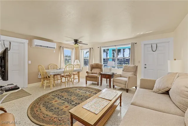 a living room with furniture a rug and a table
