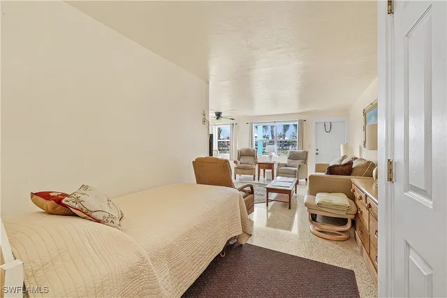 a bedroom with a bed and a large window