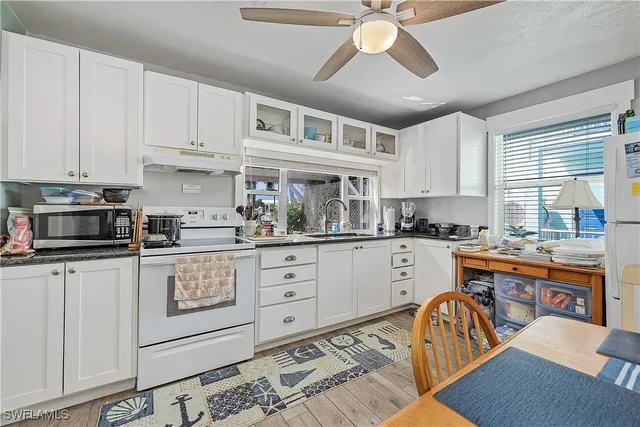 a kitchen with stainless steel appliances granite countertop a sink and cabinets
