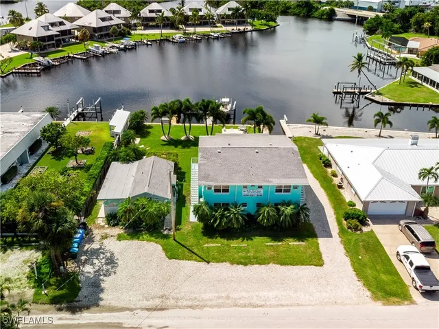 an aerial view of a house with a lake view