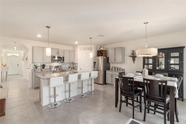 a kitchen with stainless steel appliances granite countertop white cabinets and a stove
