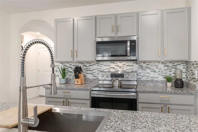 a bathroom with a shower sink vanity and mirror