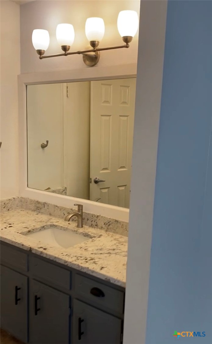 1316 Opal Road, Unit A Killeen, TX 76543 - Photo 19 of 25 a bathroom with a granite countertop sink and a mirror