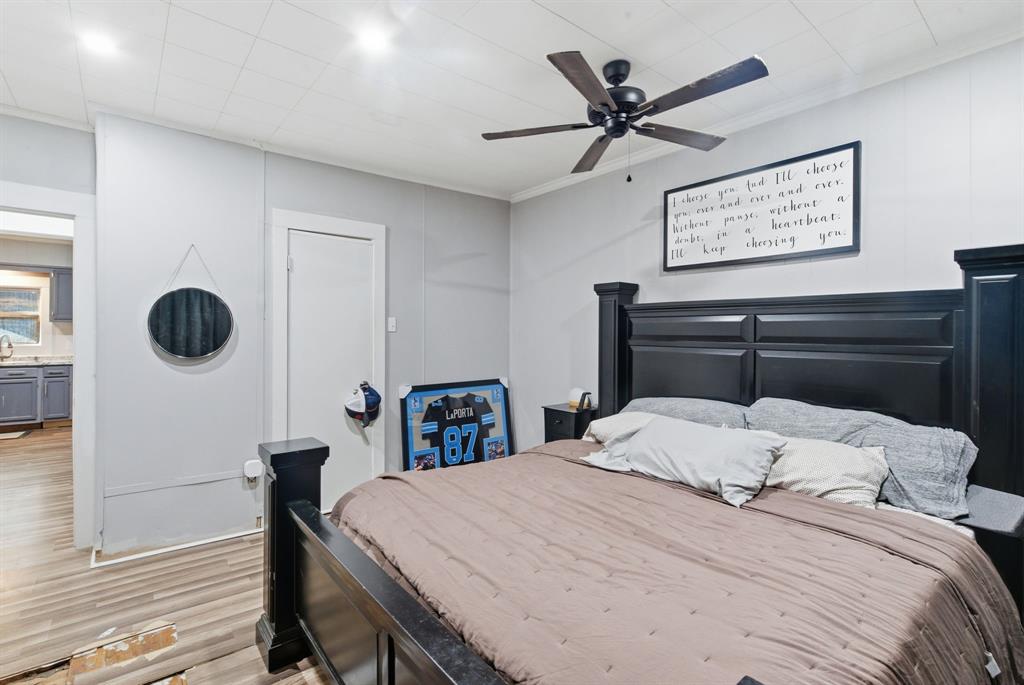 1317 4th Street Graham, TX 76450 - Photo 15 of 25 Bedroom featuring light wood-style flooring and a ceiling fan