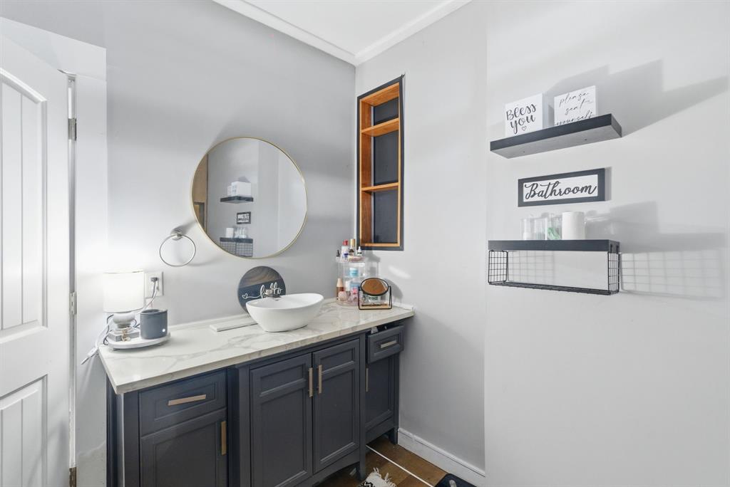 1317 4th Street Graham, TX 76450 - Photo 16 of 25 Bathroom with vanity and ornamental molding