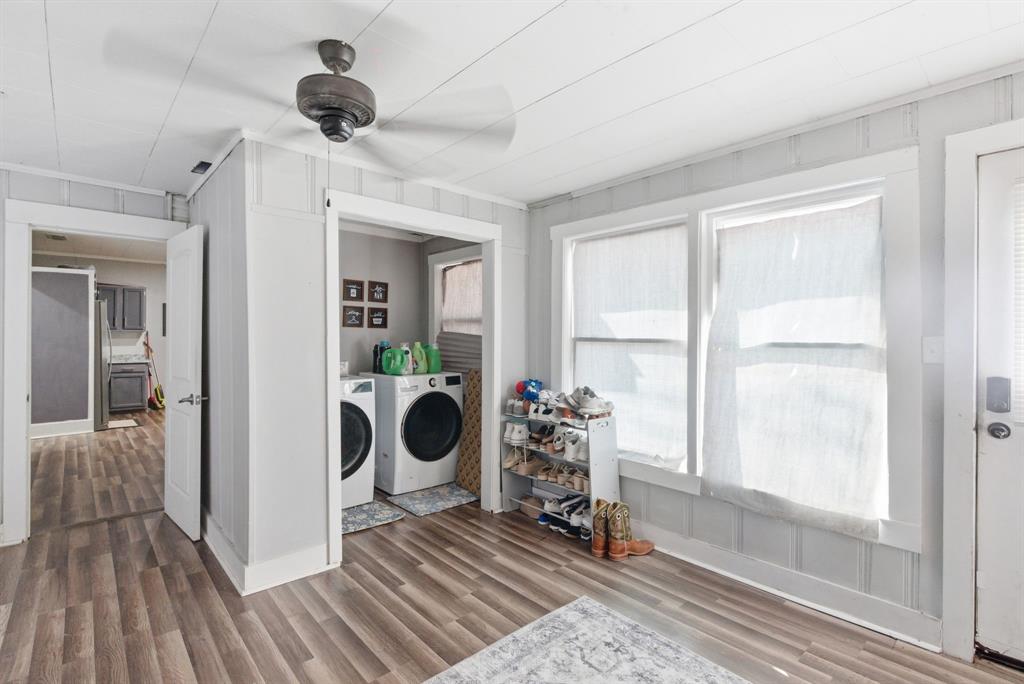 1317 4th Street Graham, TX 76450 - Photo 17 of 25 Laundry area featuring washing machine and clothes dryer and wood finished floors