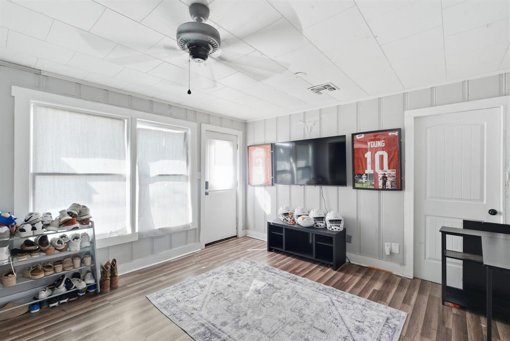 1317 4th Street Graham, TX 76450 - Photo 18 of 25 Living area featuring wood finished floors and a decorative wall
