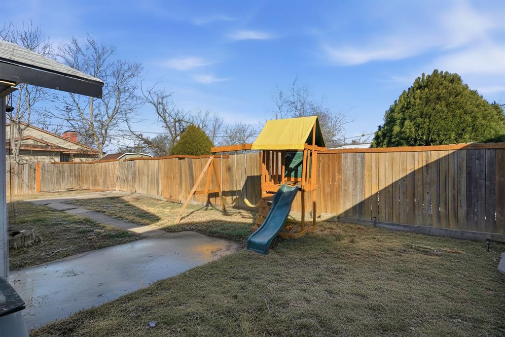 1317 4th Street Graham, TX 76450 - Photo 19 of 25 View of play area featuring a fenced backyard