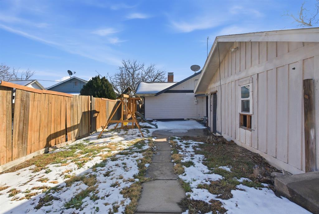 1317 4th Street Graham, TX 76450 - Photo 21 of 25 Yard layered in snow featuring a fenced backyard and a patio