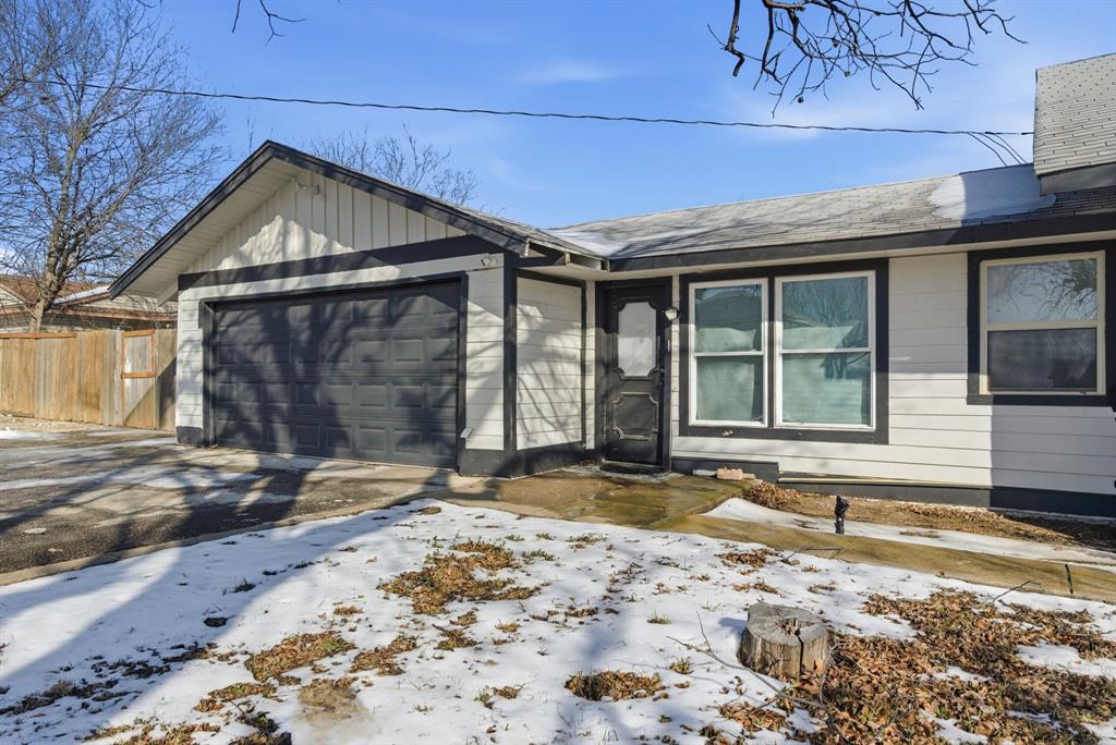 1317 4th Street Graham, TX 76450 - Photo 25 of 25 View of front of house with driveway, a garage, and board and batten siding