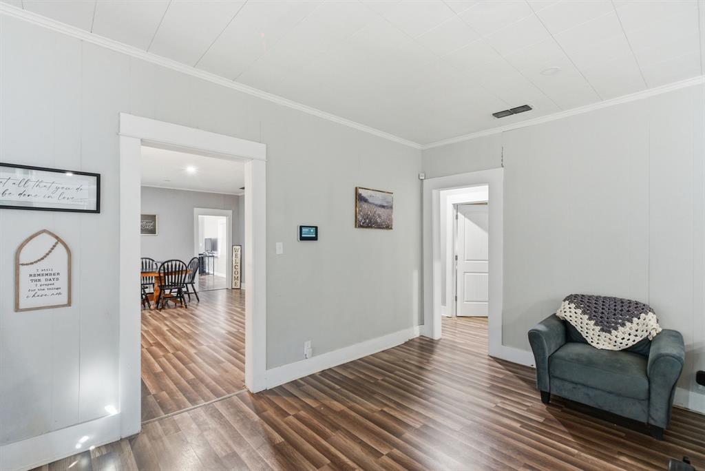 1317 4th Street Graham, TX 76450 - Photo 6 of 25 Sitting room featuring ornamental molding and dark wood-style floors