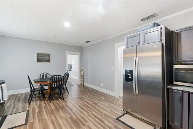 a dining room with furniture and wooden floor