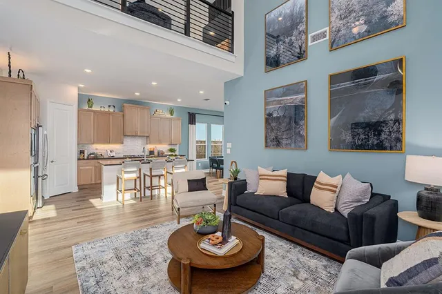 a living room with furniture kitchen and a table