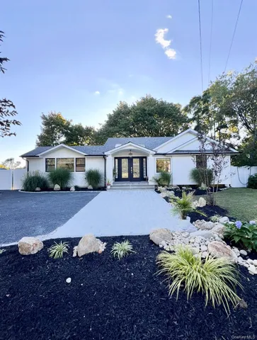 a front view of house with yard and seating space