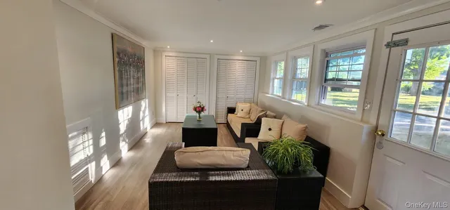 a living room with furniture and a wooden floor