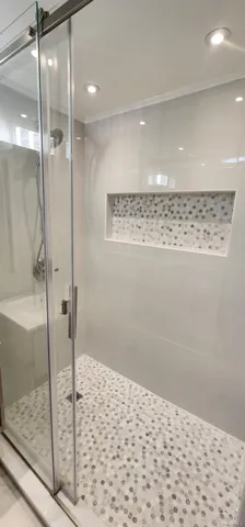 a bathroom with a tub sink mirror and toilet