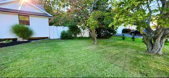 a view of a swimming pool with a table and chairs under an umbrella