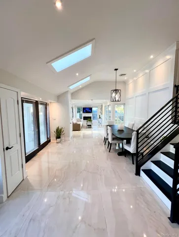 a living room with furniture and a piano