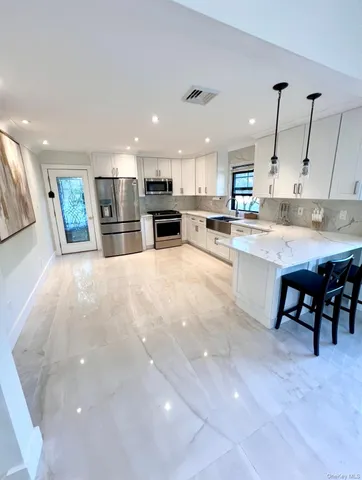 a large kitchen with cabinets and a counter top space