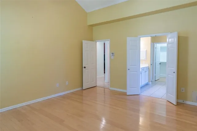 a view of an empty room with wooden floor