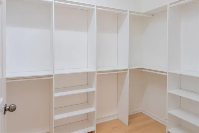 a view of walk in closet with empty racks