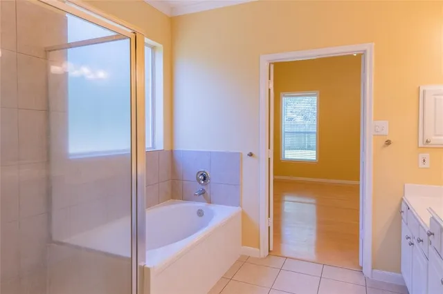 a bathroom with a tub and shower
