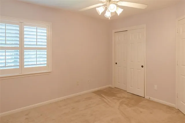 an empty room with windows and closet