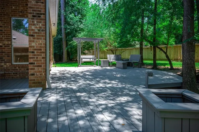 a view of a backyard with table and chairs and wooden fence