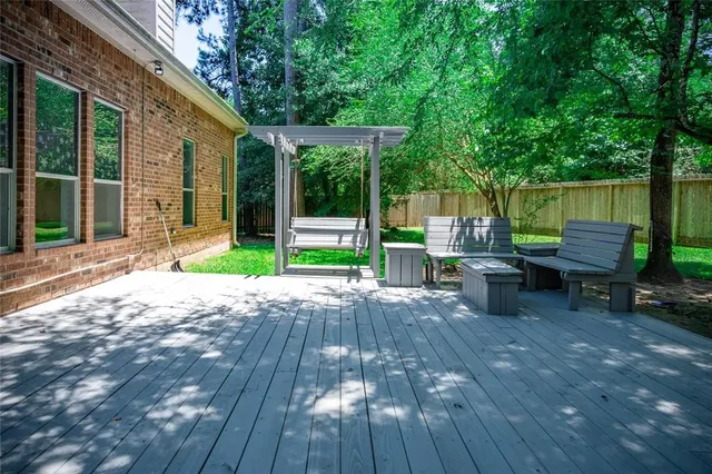 a view of a house with backyard and sitting area