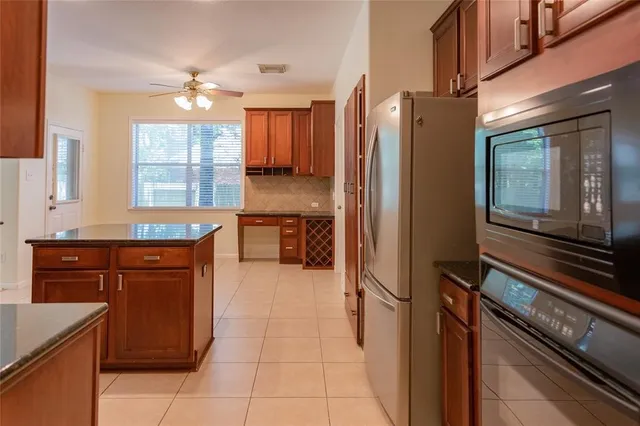 a kitchen with stainless steel appliances granite countertop a refrigerator and a sink